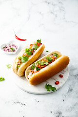 Hot dogs with red pepper and cilantro