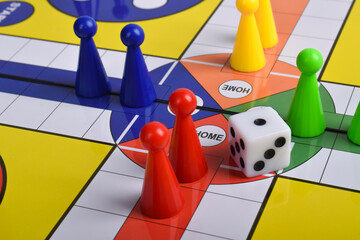 Ludo game board with figures and dice isolated on white background, close up