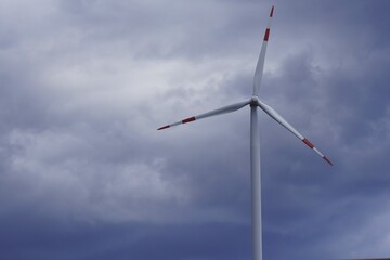 Modern wind turbines generating clean, renewable energy symbolize sustainable climate solutions and...
