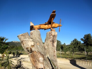 model plane on tree trunk stump
