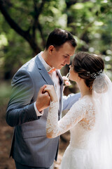 portrait of an elegant groom in a blue suit