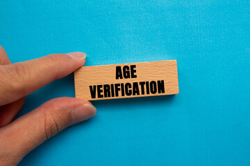 Age Verification message written on wooden block on blue background. Conceptual Age Verification symbol. Copy space.