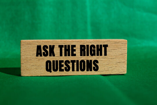 Ask The Right Questions message written on wooden block on green background. Conceptual Ask The Right Questions symbol. Copy space.