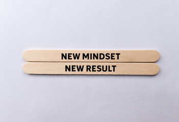 New mindset new result message written on wooden sticks on white background. Conceptual new mindset...