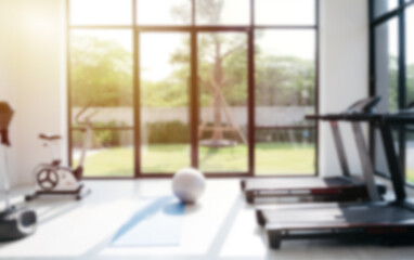 Modern home gym with large sunny windows

