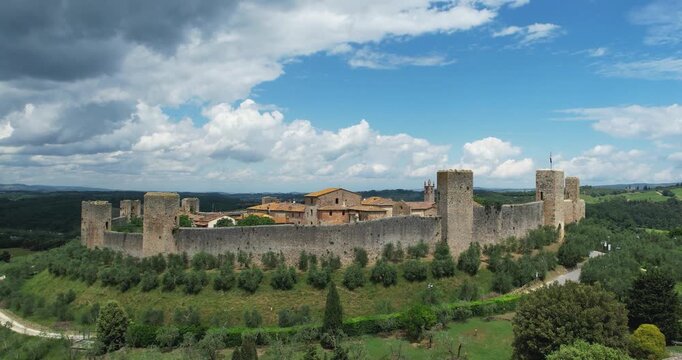 Breathtaking medieval walls of Monteriggioni, located in Tuscany, Italy, stand surrounded by idyllic landscapes. Known for its historical significance and preservation