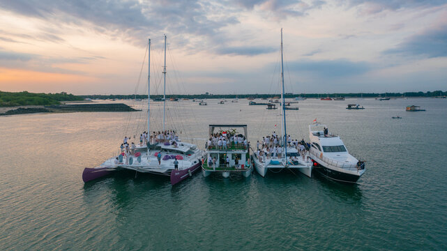 Aerial view of several yachts clustered together in the calm, reflective waters off the coast, Bali, Indonesia.