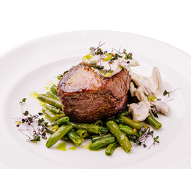 Delicious gourmet steak served with green beans and mushroom sauce