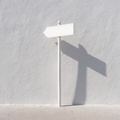 A minimalist white signpost against a textured white wall, casting a gentle shadow, conveying simplicity and direction.