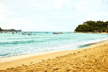 El Nido, Palawan Philippines - December 18, 2023: Boats and beach bars in El Nido beach.Palawan, people on white sandy beach in popular tourist destination of El Nido, Palawan. 