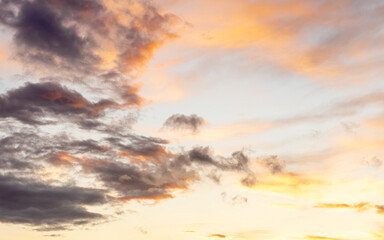 clouds under a red, yellow, and blue sky at sunset