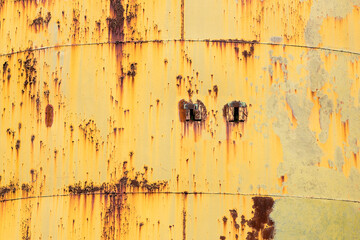 curved metal surface texture in rusted and weathered yellow and green tones