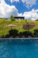 Modern cabins and swimming pool in the Carpathians on a sunny day