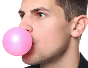 A close-up of a man blowing a pink bubble gum bubble, showcasing his focused expression and the vibrant color of the gum against a dark background.