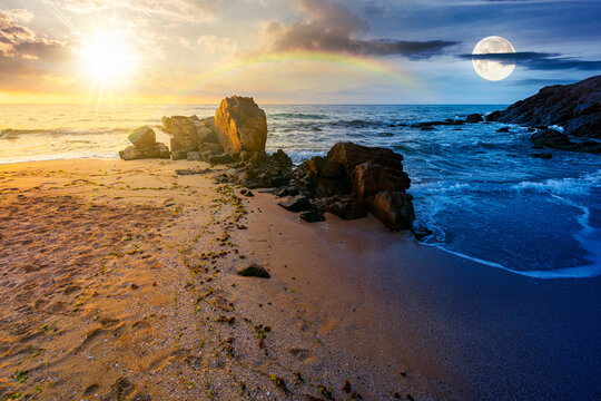 landscape by the sea in summer. day and night time change concept. beautiful beach with rocks washed by calm waves with sun and moon at twilight. view to horizon under blue sky with clouds