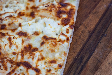 Close up on Gyuzleme dough stuffed with quark on a wooden table