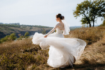 bride blonde girl with a bouquet in the forest
