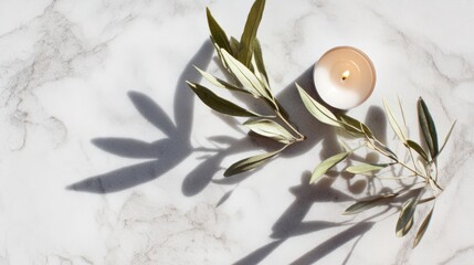 A glowing peace candle surrounded by olive leaves on marble, symbolizing tranquility and harmony.