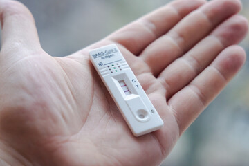 SARS-CoV-2 rapid antigen test with two colored lines - positive result of coronavirus infection on...