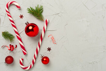 Christmas composition with lollipops on concrete background, top view