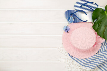 Blue beach accessories on wooden background, top view. Copy space for text