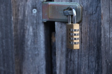 A gold lock with a key hanging from it