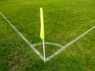 Yellow corner flag on soccer pitch