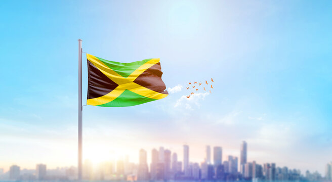 Jamaica national flag waving with skyline and buildings. Jamaica national flag for independence day.