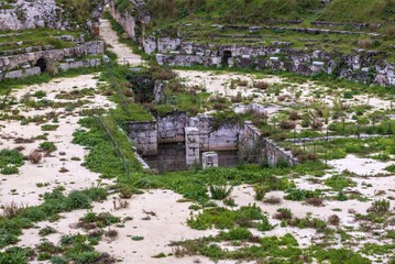 Arena of Roman Amphitheater in Neapolis archaeological park of Syracuse, Sicily Island in Italy