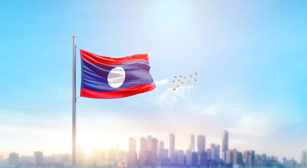 Laos national flag waving with skyline and buildings. Laos national flag for independence day.