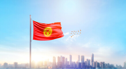 Kyrgyzstan national flag waving with skyline and buildings. Kyrgyzstan national flag for...
