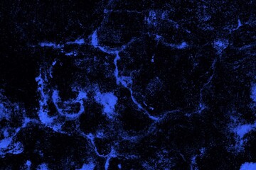 Close-up view of a blue textured wall showing rough patterns and intricate shadow details, offering...