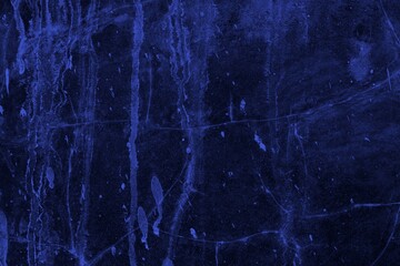 Close-up view of a blue textured wall showing rough patterns and intricate shadow details, offering a visually appealing background texture for versatile creative uses.