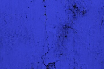 Close-up view of a blue textured wall showing rough patterns and intricate shadow details, offering...