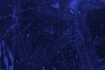 Close-up view of a blue textured wall showing rough patterns and intricate shadow details, offering a visually appealing background texture for versatile creative uses.