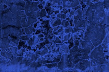 Close-up view of a blue textured wall showing rough patterns and intricate shadow details, offering a visually appealing background texture for versatile creative uses.