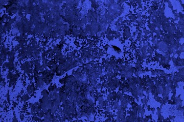 Close-up view of a blue textured wall showing rough patterns and intricate shadow details, offering...