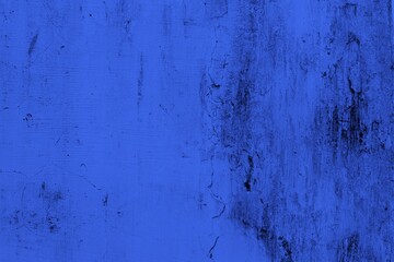 Close-up view of a blue textured wall showing rough patterns and intricate shadow details, offering a visually appealing background texture for versatile creative uses.