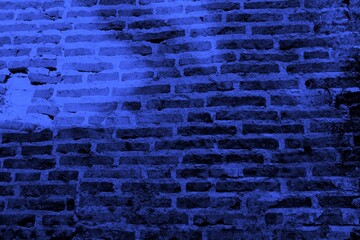Close-up view of a blue textured wall showing rough patterns and intricate shadow details, offering...