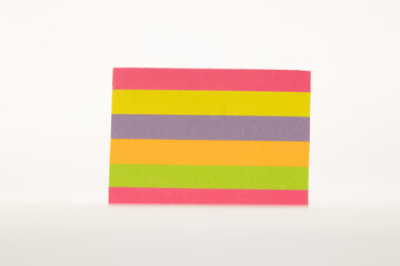 Obraz premium Colorful sticky notes arranged in a stack, isolated on a clean white background