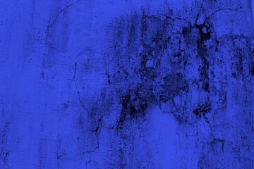 Close-up view of a blue textured wall showing rough patterns and intricate shadow details, offering...