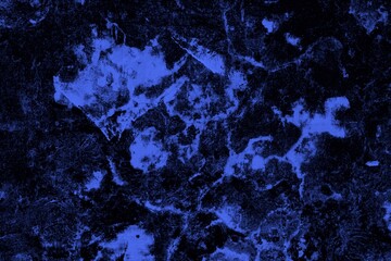 Close-up view of a blue textured wall showing rough patterns and intricate shadow details, offering...