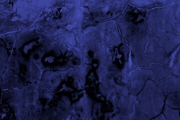 Close-up view of a blue textured wall showing rough patterns and intricate shadow details, offering...