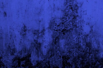 Close-up view of a blue textured wall showing rough patterns and intricate shadow details, offering...