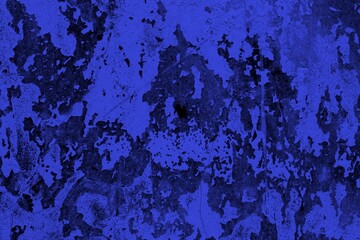 Close-up view of a blue textured wall showing rough patterns and intricate shadow details, offering...