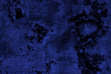 Close-up view of a blue textured wall showing rough patterns and intricate shadow details, offering...