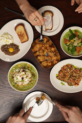 Overhead View of a Couple Sharing a Variety of Gourmet Dishes