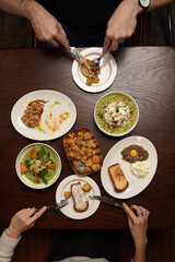 Overhead View of a Couple Sharing a Variety of Gourmet Dishes