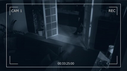 Security camera footage of two unrecognizable thieves wearing black balaclava just broke into house at night and starting looking for cash