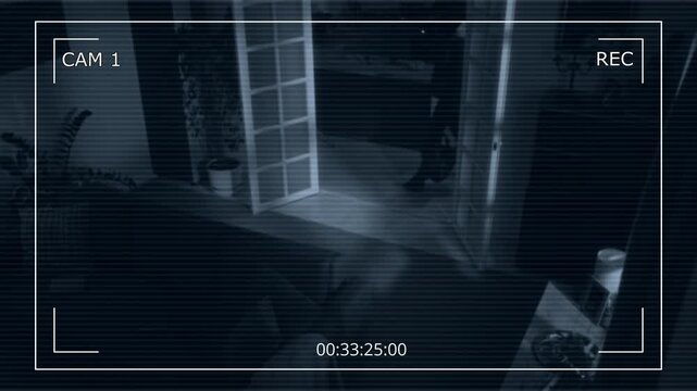 Security camera footage of two unrecognizable thieves wearing black balaclava just broke into house at night and starting looking for cash